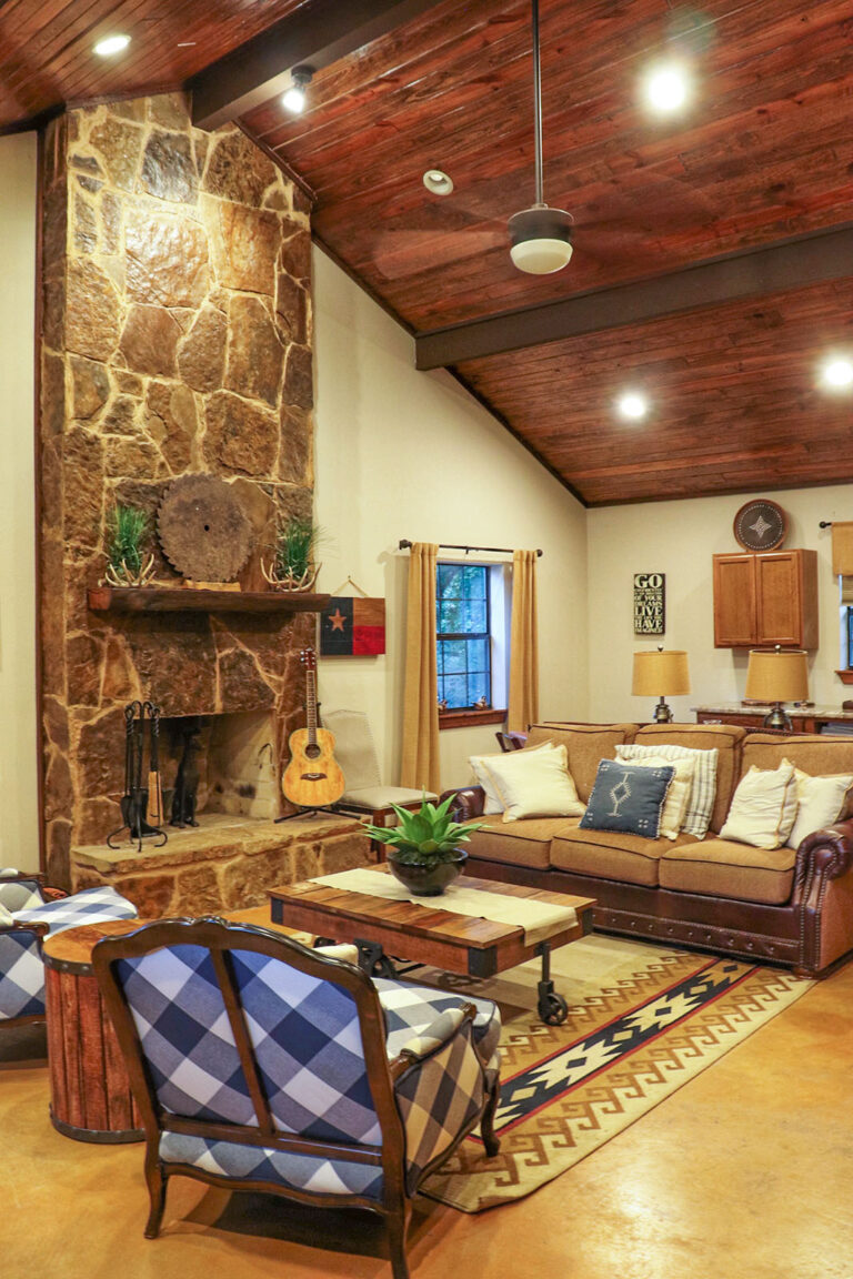 common room with seating, fireplace, guitar, furnishings