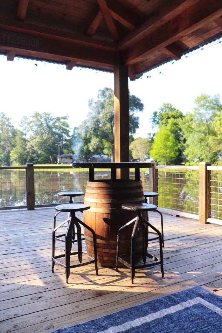 barrel table with chairs overlooking lake