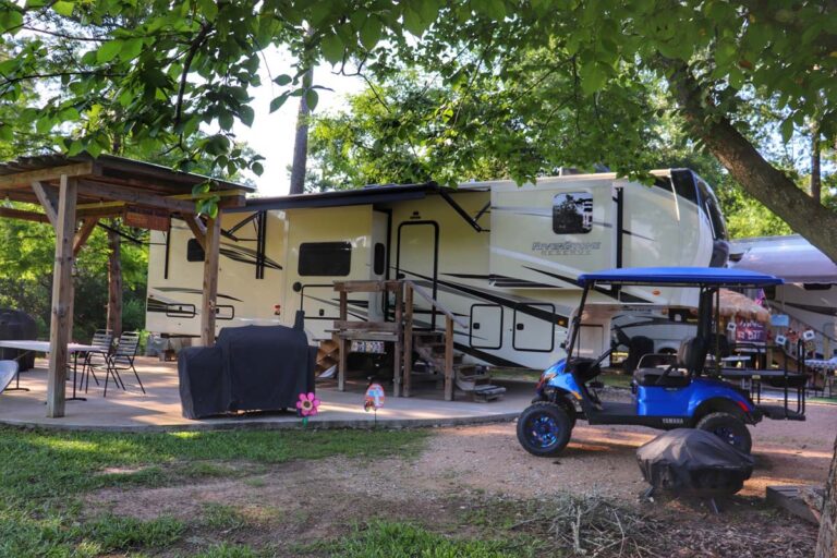 rv parked with golf cart and decorations